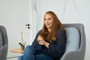 Helen sitting in a chair smiling